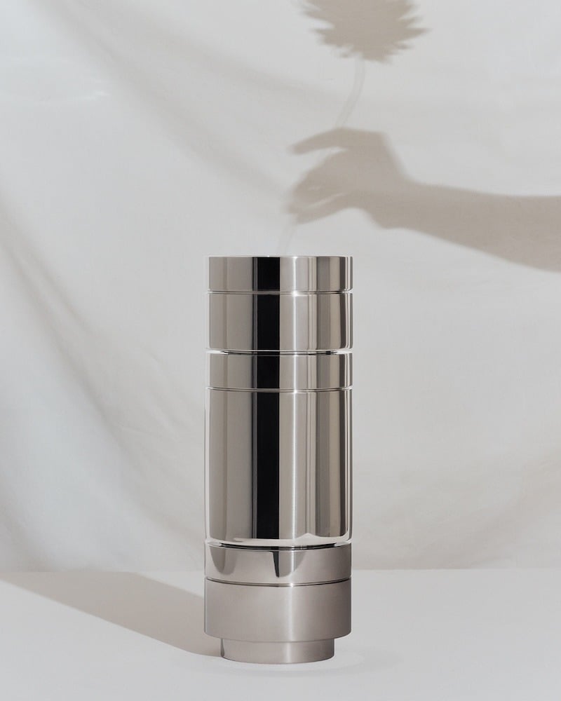 Shiny metal 'cans' stacked to form a column. Designed by EOOS Design