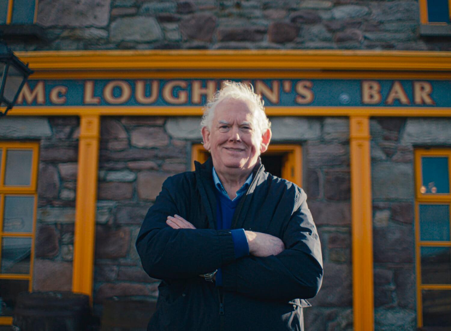 Proprietor Josie McLoughlin in front of the pub that bears his family's name 