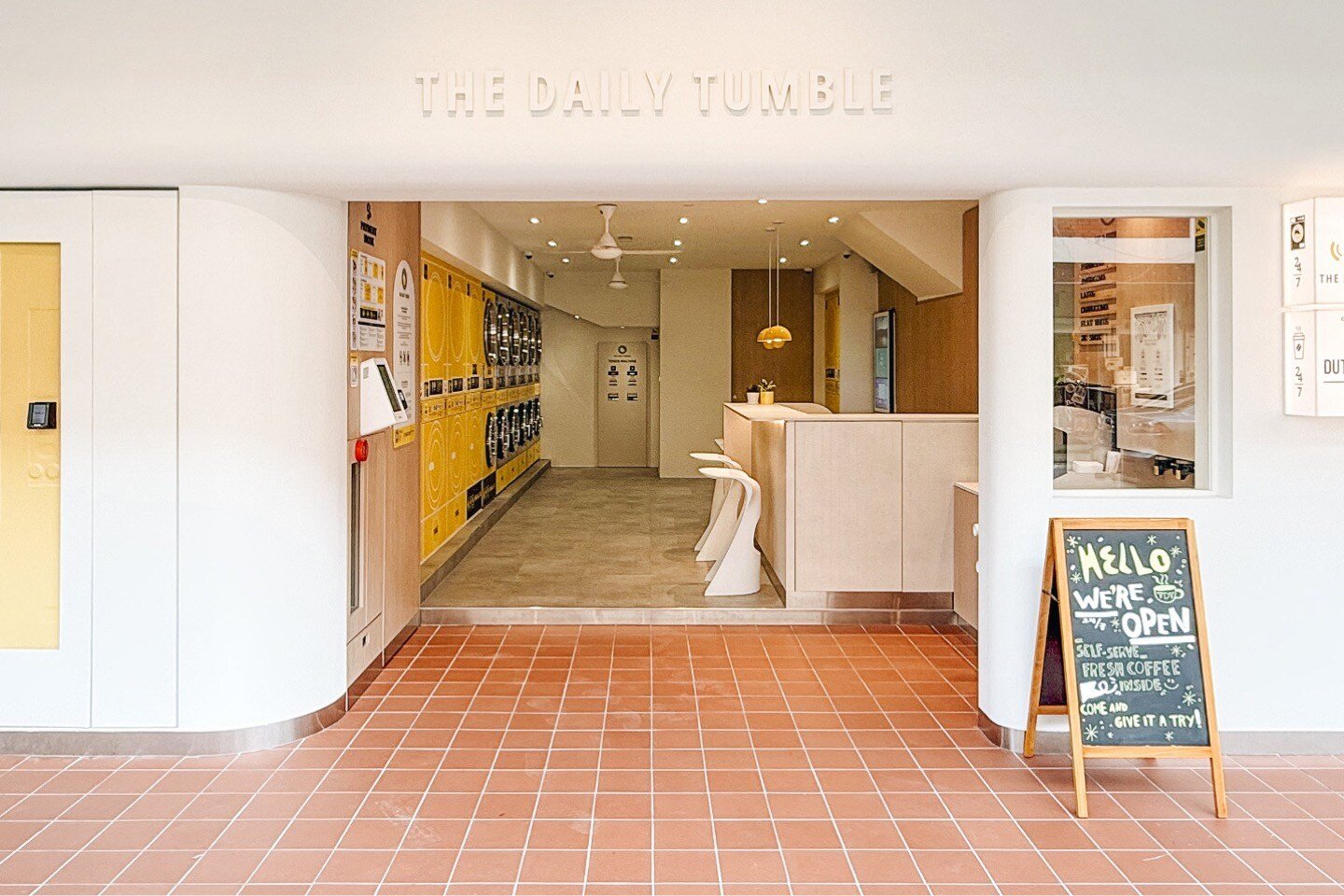 Exterior view of The Daily Tumble, a laundromat in soft neutrals 
