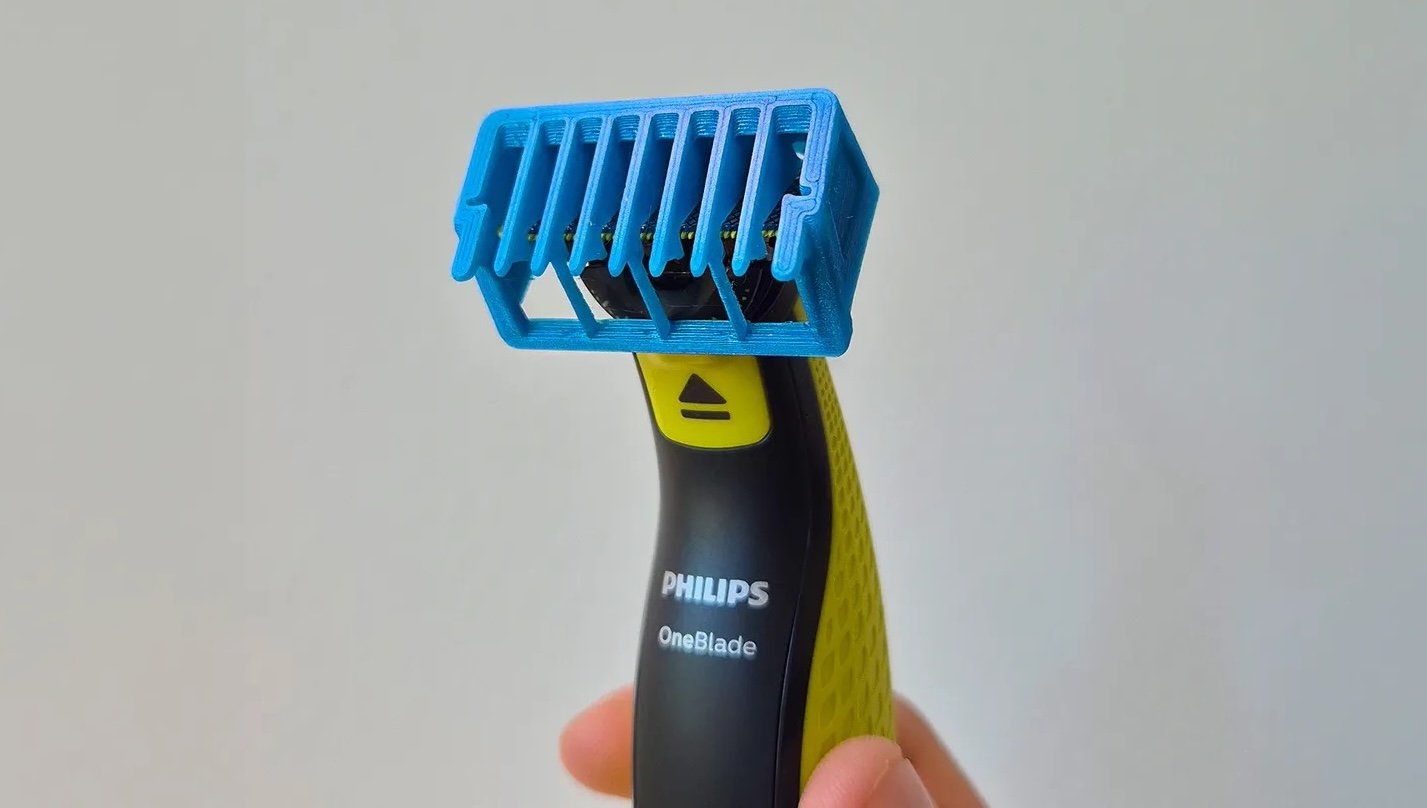 A Philips beard trimmer fitted with a blue, 3D-printed replacement part 