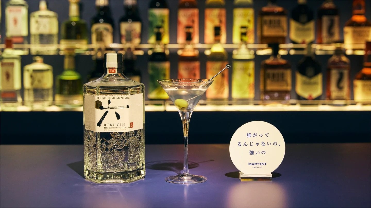A bottle of gin, a cocktail and a coaster with the text 'I'm not pretending to be strong' 